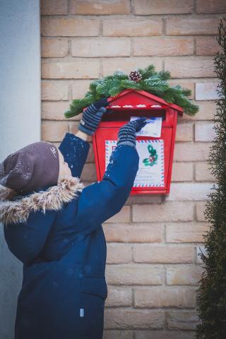 Child Placing Letter in Mailbox