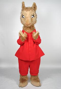 A brown llama is dressed in red pajamas.