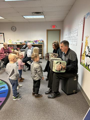 Two Polka Musicians Performing for Children