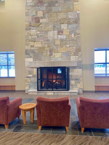 comfortable chairs by library fireplace