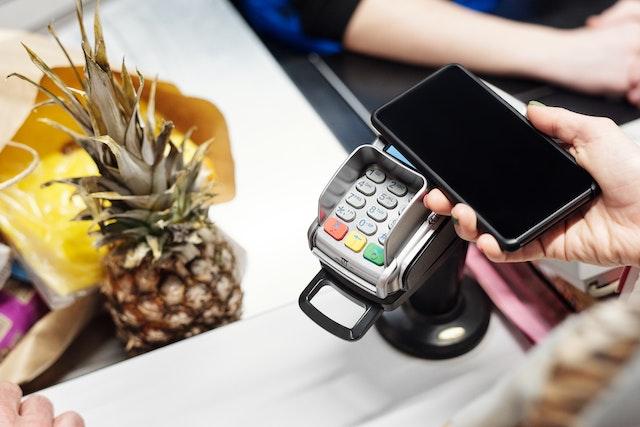 Photo of smartphone being used to pay at grocery store