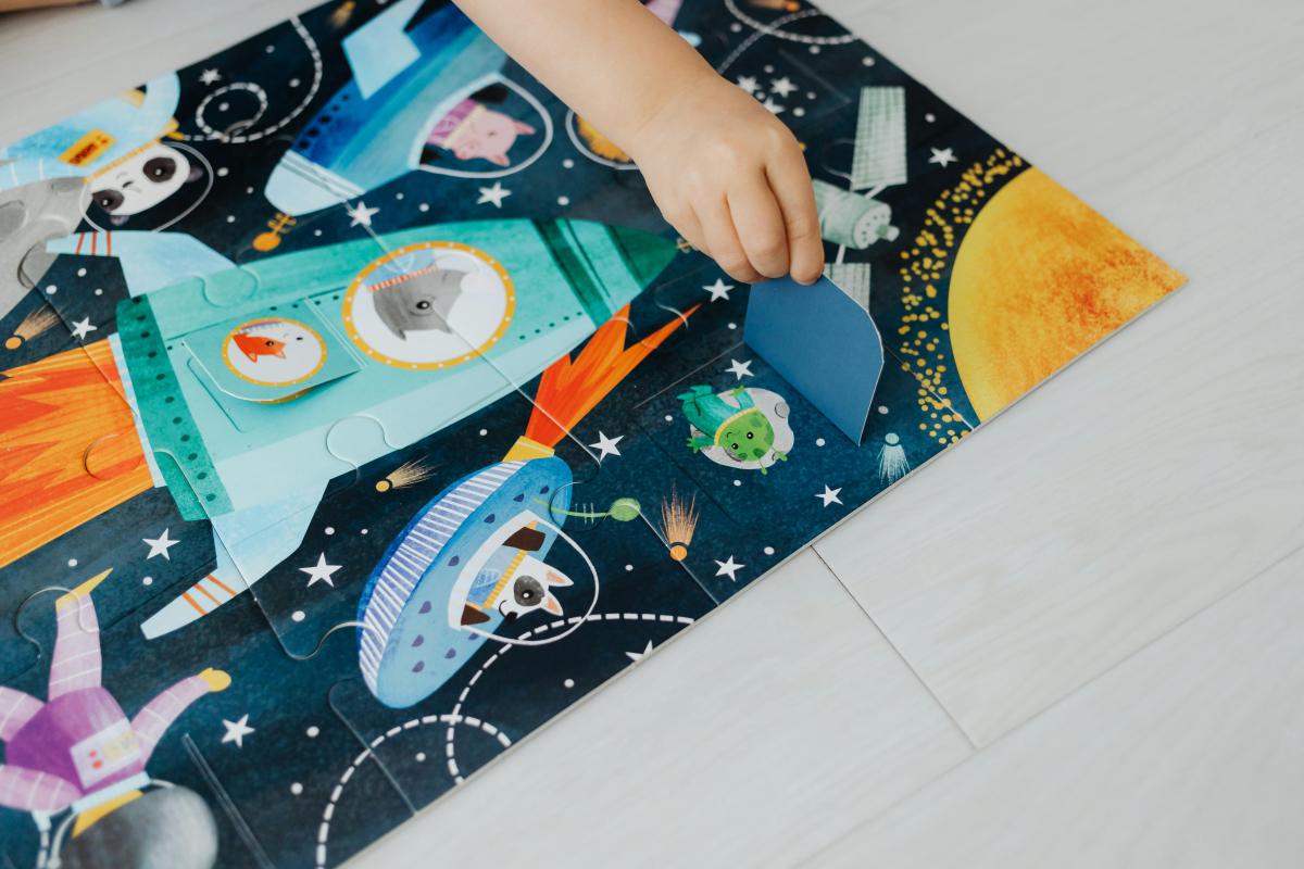 Child Playing with Outer Space Puzzle