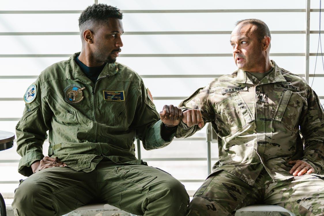 Two Servicemen Fist Bumping